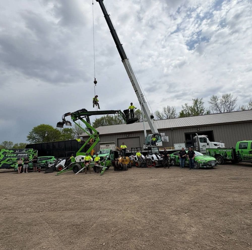 Team operating heavy machinery outdoors near equipment at a construction site.